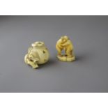 A well modelled miniature ivory Pomegranate, the interior amusingly carved with a crowd of