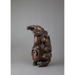 A large carved bamboo Liuhai and toad group, the immortal seated on his mount, c 1800 - - H30cm