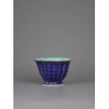 A gilt inscribed blue lobed cup, 18th century , the interior and base enamelled turquoise - - W 9.