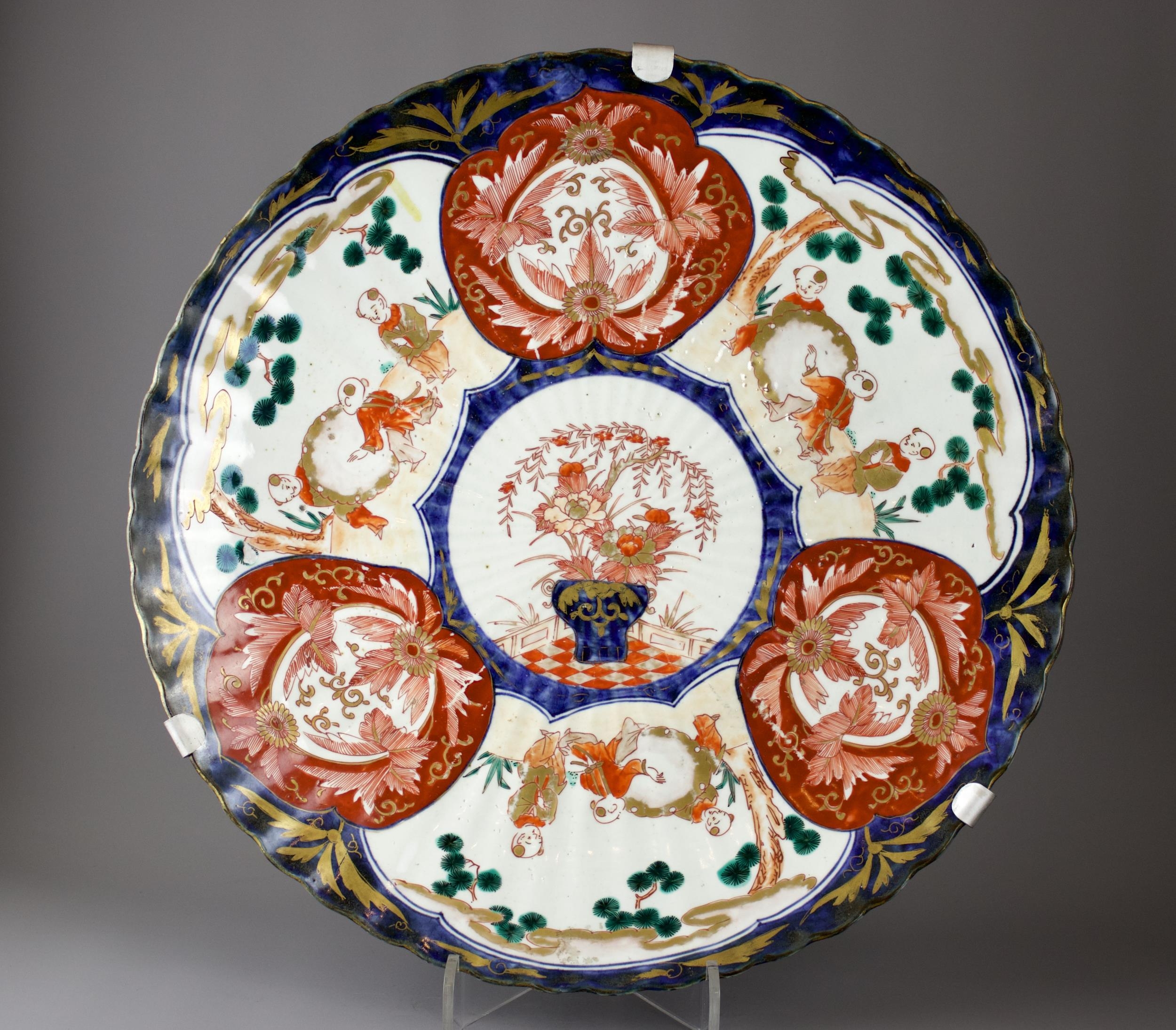 A Japanese Imari Fluted Dish, c. 1900 - - W45.5cm H5.5cm - - the shallow well with three vignettes - Image 5 of 5
