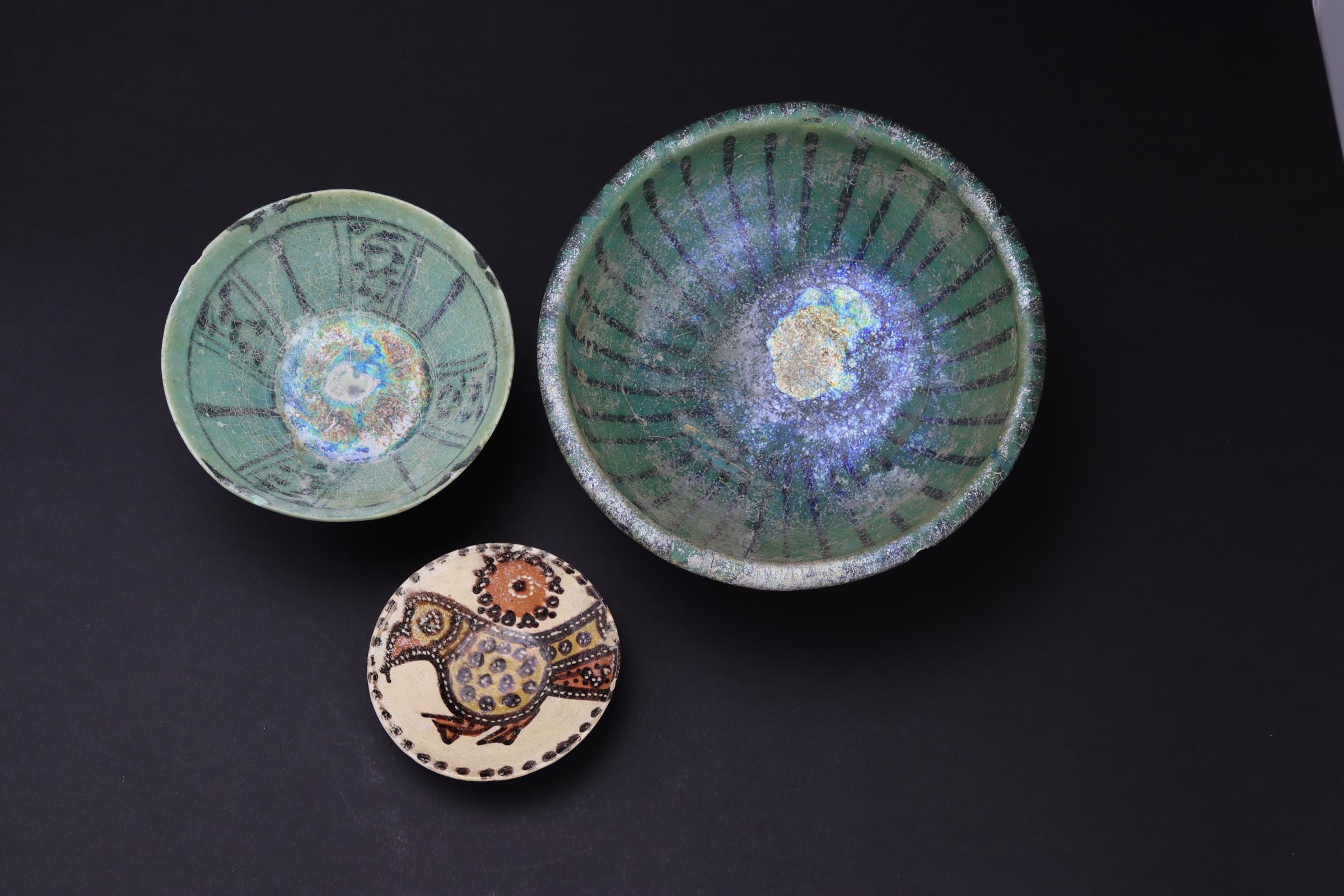 A Samanid pottery bowl, decorated with a bird, 10th/11th century, and two turquoise glazed Kashan