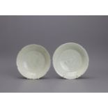 Two qingbai petal rimmed carved bowls, Southern Song Dynasty, carved with peony in the central