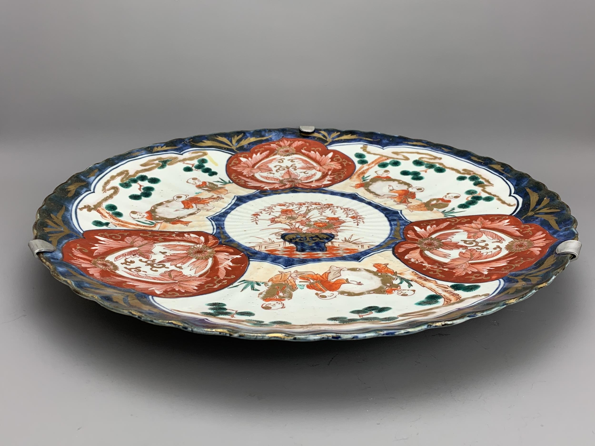 A Japanese Imari Fluted Dish, c. 1900 - - W45.5cm H5.5cm - - the shallow well with three vignettes - Image 3 of 5