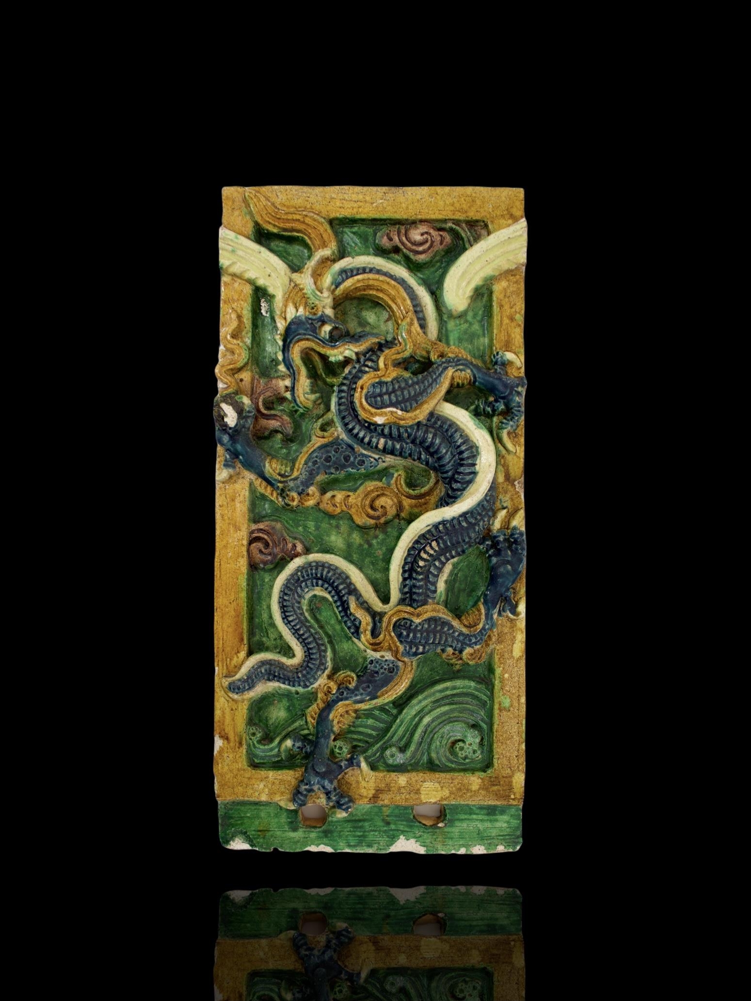 A blue, amber and green glazed Dragon Tile, Ming Dynasty - - L54.5cm W25.5cm - - of upright