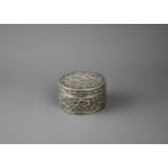 A Chinese export silver cylindrical box and cover, c1890 D8.4cm H4.9cm 140g marked WH, finely chased