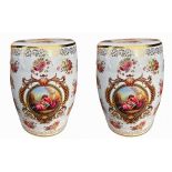 A PAIR OF DECORATIVE PORCELAIN GARDEN SEATS Decorated with panels of roses, gilded decoration and