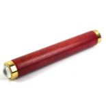 A 20TH CENTURY RED LEATHER AND BRASS BOUND MODEL OF A KALEIDOSCOPE. (length 26cm) Condition: in good