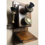 A VINTAGE WALL MOUNTED MAHOGANY AND BRASS STICK TELEPHONE. Condition overall good in accordance with