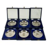 A SET OF SIX SILVER PRESENTATION DISHES, Circular form with embossed emblem with Royal Navy