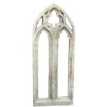 A FAUX STONE FRAMED MIRROR in the form of a gothic pointed arch. 36 x 90cm Condition good