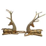 A PAIR OF LARGE CONTINENTAL DECORATIVE POLISHED HEAVY BRASS MODELS OF SEATED FOREST DEERS. (h 55cm x