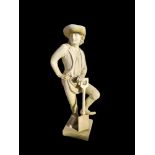 A RECONSTITUTED STONE STATUE OF A FIELD HAND, with spade. Designed by Capability Brown 142cm