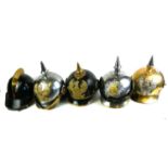 A COLLECTION OF 20TH CENTURY THEATRICAL HELMETS To include three German pickelhaube helmets with