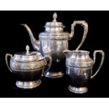 AN EARLY 20TH CENTURY CONTINENTAL SILVER THREE PIECE COFFEE SERVICE Classical form with acorn finial