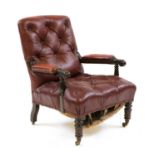 A Victorian red leather button back armchair,