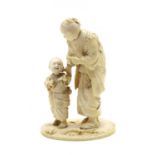 A Japanese sectional carved ivory figure of a mother and child