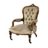 A Victorian walnut line inlaid and gilt carved armchair,