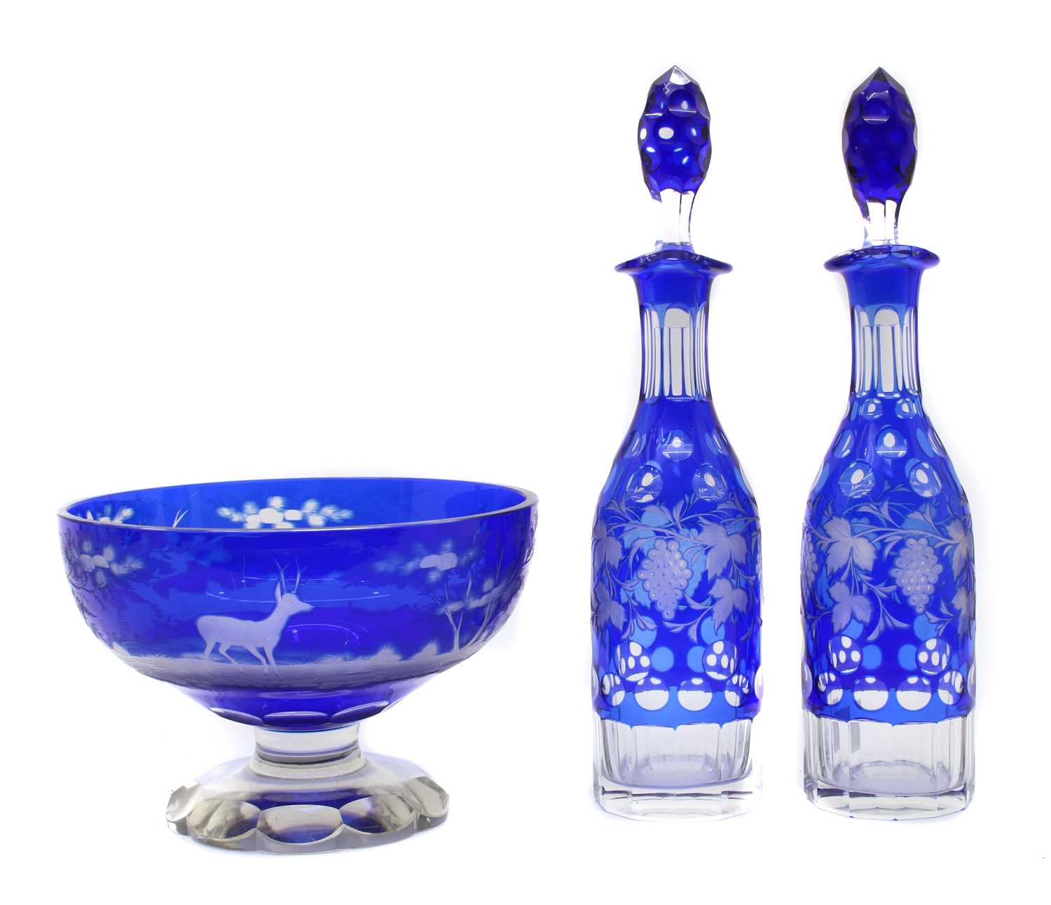 A pair of Bohemian glass overlay decanters,