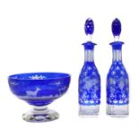 A pair of Bohemian glass overlay decanters,