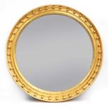A large Regency-style convex wall mirror,