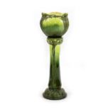 A Burmantofts Faience Pottery green glazed jardinière on stand,