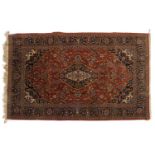 A Persian wool rug,