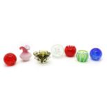 Various glass items, comprising: three spherical bubbled doorstops,