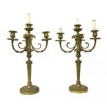 A pair of brass three-branch candelabrum