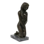 A bronze kneeling nude