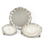 A set of three graduated silver salvers,