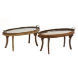 Two similar, Edwardian strung, inlaid and crossbanded mahogany oval trays on stands,