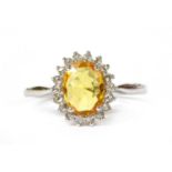 A white gold yellow sapphire and diamond cluster ring,
