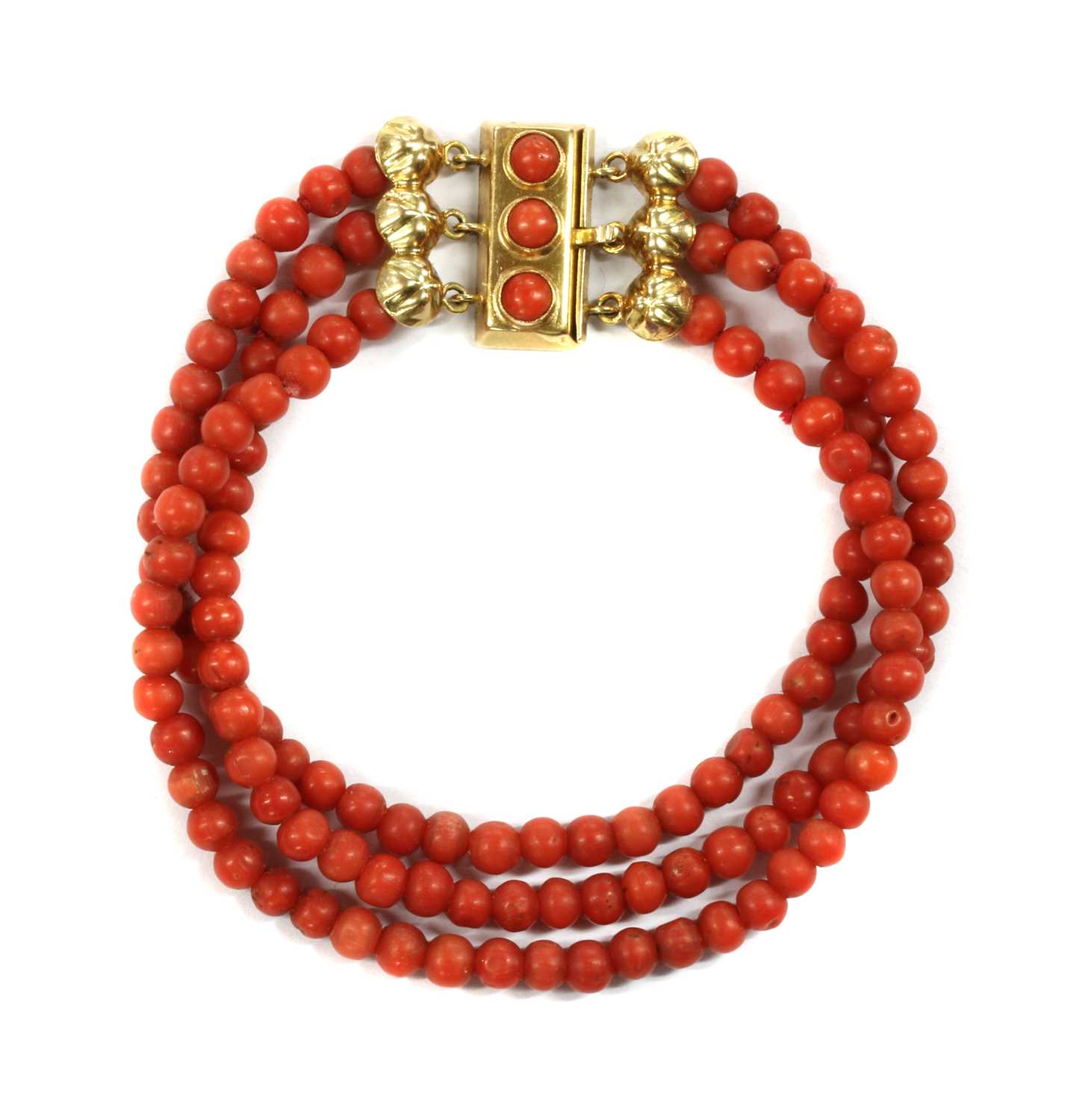 A three row uniform coral bead bracelet,
