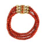 A three row uniform coral bead bracelet,