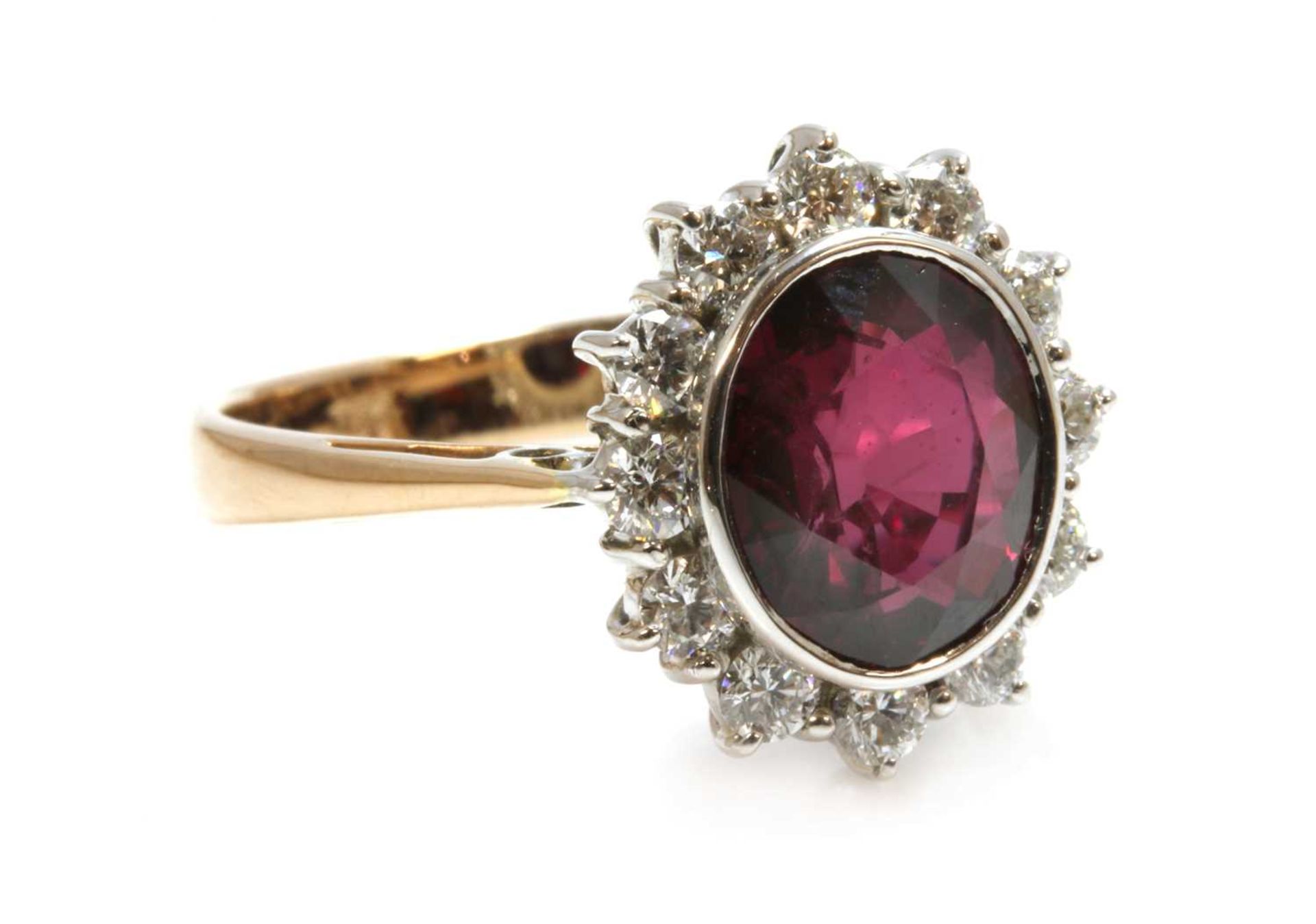 A gold ruby and diamond oval cluster ring,