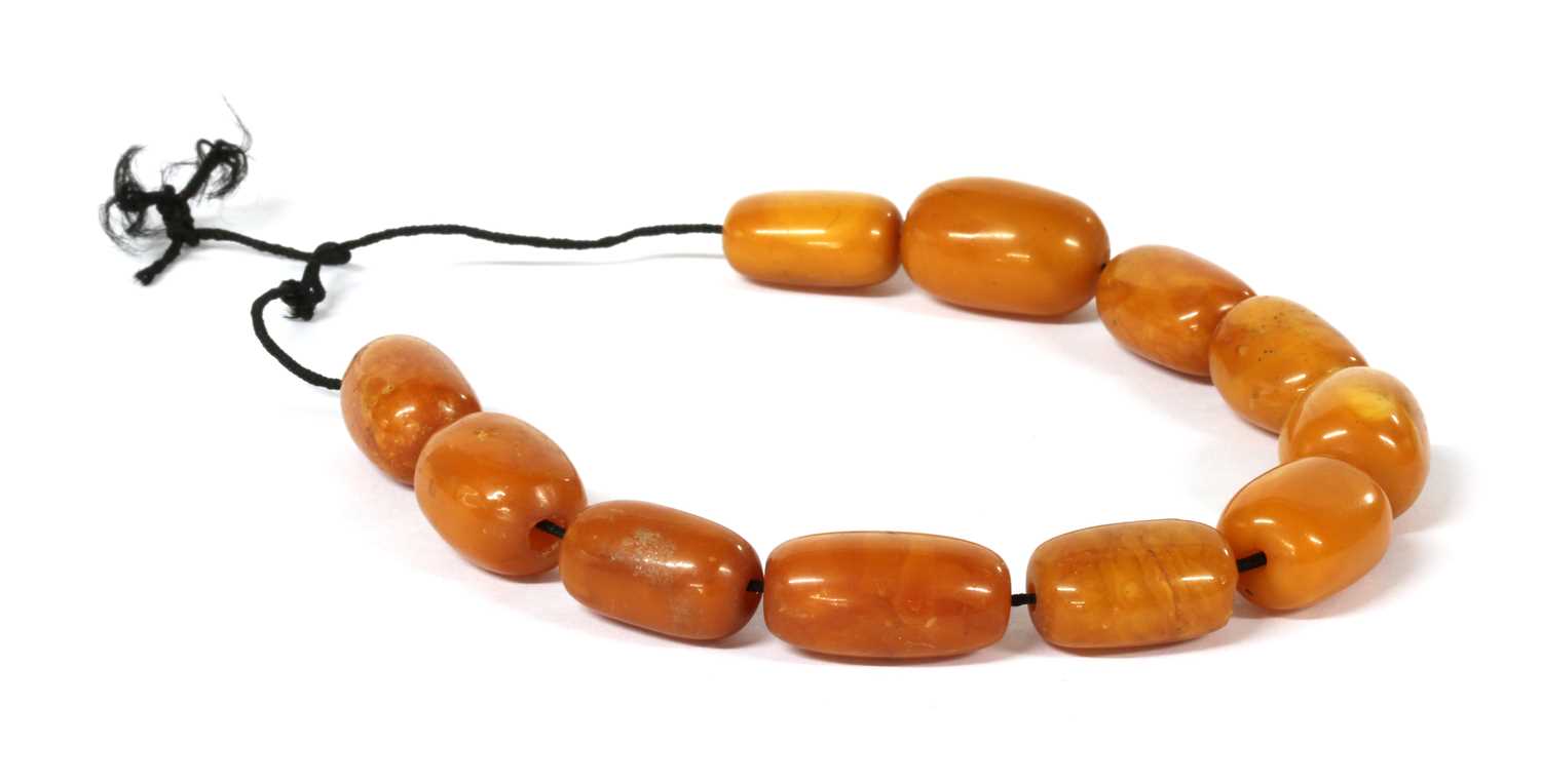 Eleven butterscotch amber beads,