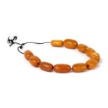 Eleven butterscotch amber beads,