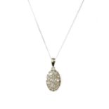 A white gold diamond cluster pendant,