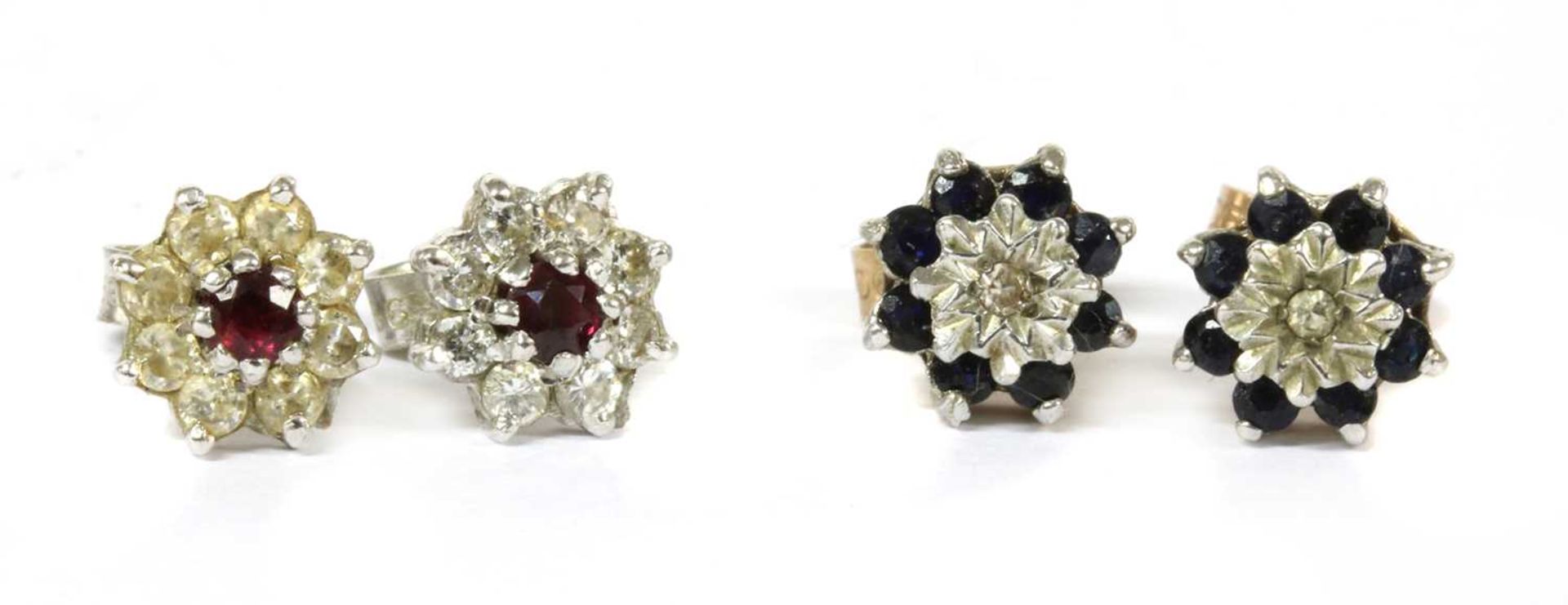 A pair of white gold ruby and diamond cluster earrings,