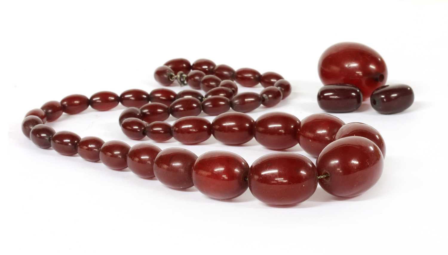 A single row graduated cherry coloured Bakelite bead necklace,