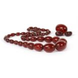 A single row graduated cherry coloured Bakelite bead necklace,