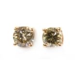 A pair of rose gold single stone diamond stud earrings,