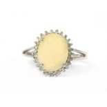 A 9ct gold opal and cubic zirconia halo cluster ring,