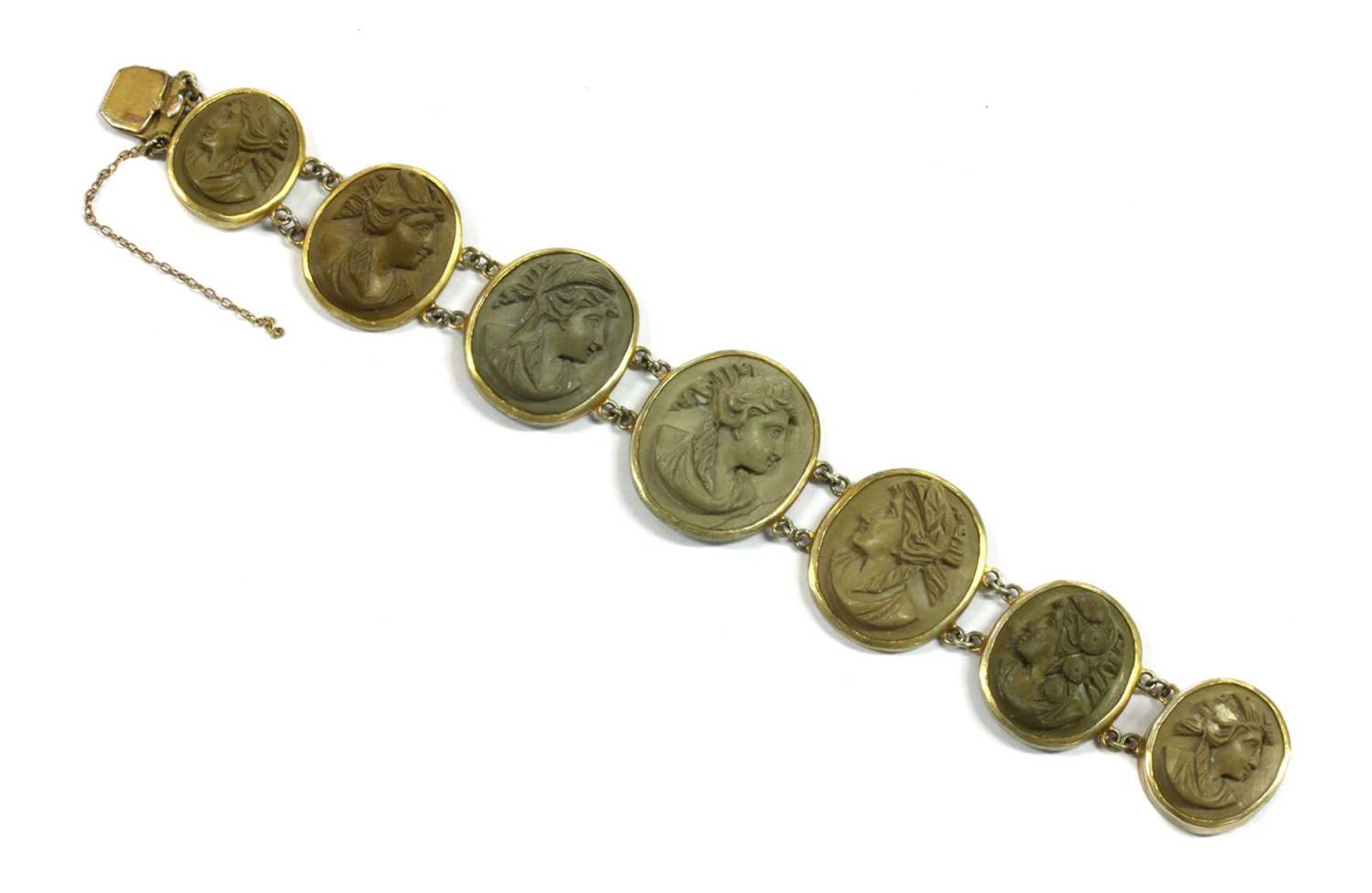 A gilt metal lava stone cameo bracelet,