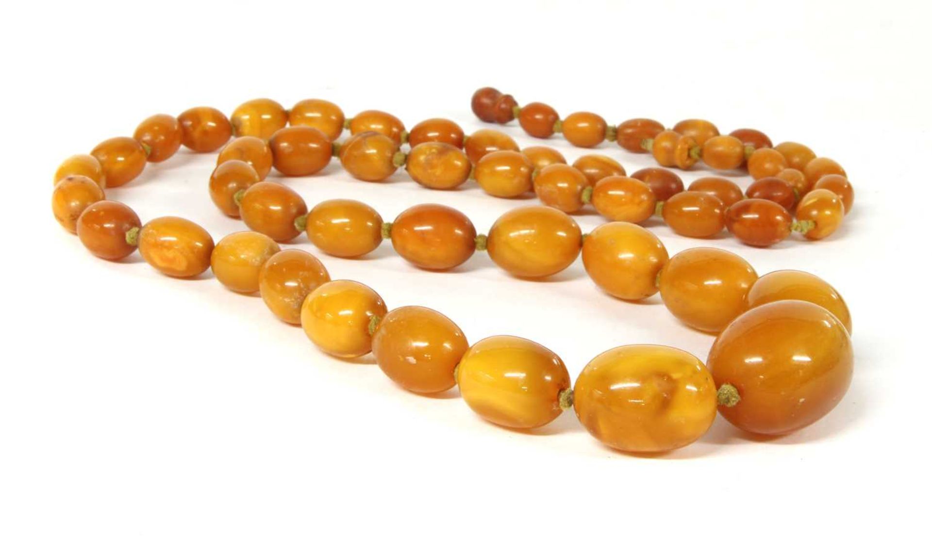 A single row graduated olive-shaped butterscotch amber bead necklace,