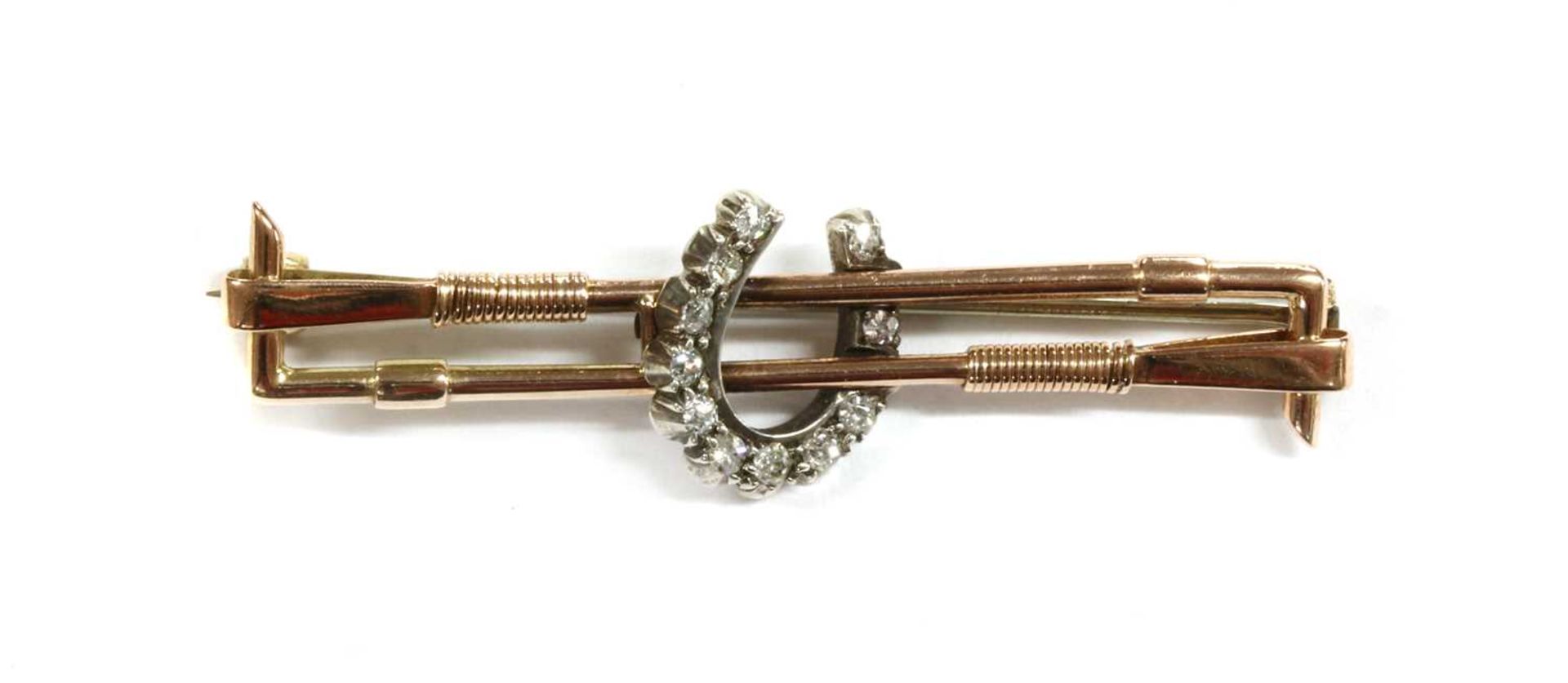 A gold and silver diamond set horseshoe bar brooch,