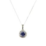 A white gold tanzanite and diamond cluster pendant,