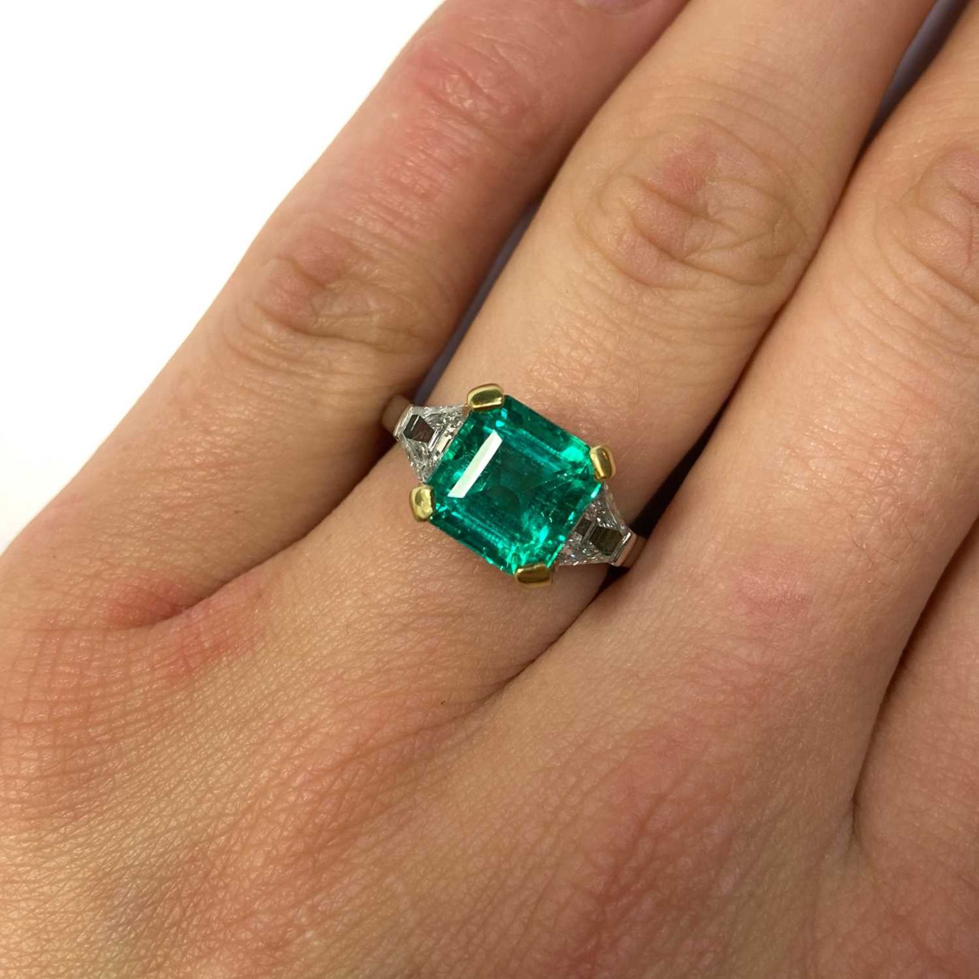 A platinum and gold Colombian emerald and diamond three stone ring, - Image 4 of 4