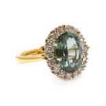 An 18ct gold green sapphire and diamond oval cluster ring,