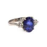 An 18ct white gold sapphire and diamond three stone ring,